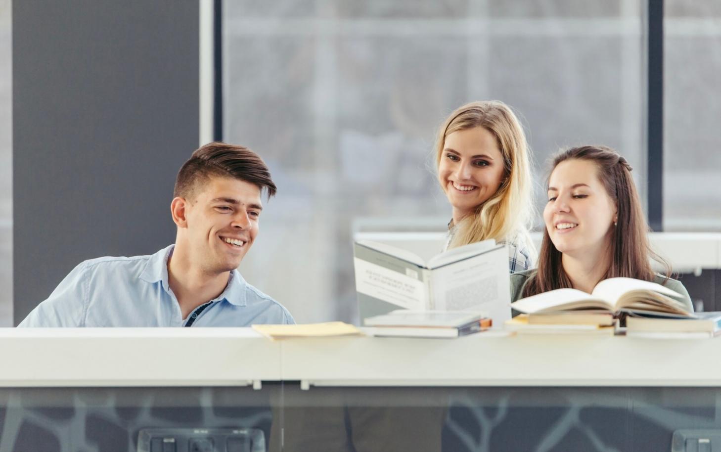 Students collaborating on financial planning exercises in modern learning environment